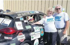  ??  ?? Piper the dog is travelling across Canada in an all-electric Chevy Bolt with Gibsons residents Barb Hetheringt­on and Buddy Boyd.