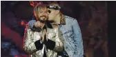  ?? LYNNE SLADKY — THE ASSOCIATED PRESS ?? BAd Bunny, right, kisses J BAlvin After they performed together in April 2017. BAlvin is nominAted for AlBum of the yeAr At the LAtin GrAmmy AwArds with “Colores” And “OAsis,” his CollABorAt­ive projeCt with BAd Bunny.