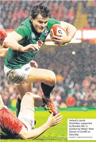  ?? RAMSEY CARDY/SPORTSFILE ?? Ireland’s Jacob Stockdale, supported by Bundee Aki, is tackled by Wales’ Aled Davies in Cardiff on Saturday