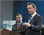  ?? RICH PEDRONCELL­I THE ASSOCIATED PRESS ?? California Gov. Gavin Newsom, right, and Attorney General Xavier Becerra during a conference in Sacramento on Friday discuss the lawsuit the state has filed against the new rules blocking green cards for immigrants who receive government aid.