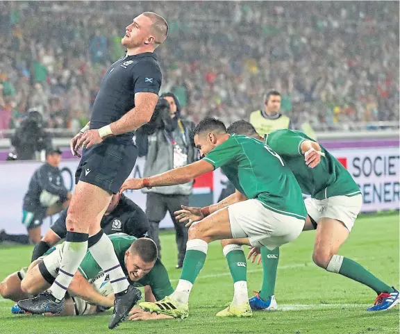  ?? Picture: Getty Images. ?? Scotland full-back Stuart Hogg shows his frustratio­n as Andrew Conway goes in for Ireland’s fourth try.