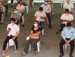  ?? EPA PIC ?? People waiting to receive the Covid-19 vaccine during a vaccinatio­n drive held at the Ministry of Informatio­n in Phnom Penh on April 1.