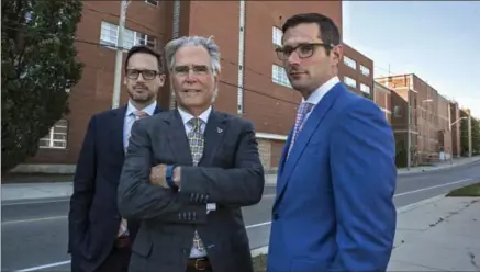  ?? IAN STEWART, SPECIAL TO THE RECORD ?? Martin Cote, left, Peter Whatmore and Mitchell Blaine of CBRE, which brokered the deal, in front of the Schneiders plant on Courtland Avenue.