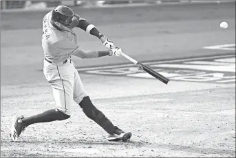  ?? ASHLEY LANDIS/AP ?? Carlos Correa hits a homer during the Astros’ win over the A’s in Game 1 of the ALDS at Dodger Stadium in Los Angeles.