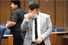  ?? RYAN SUN / AP ?? Kevin Aziz Riad shields his face as he stands in court Aug. 15 in Compton.