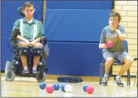  ?? NEWS PHOTO SEAN ROONEY ?? Mackenzie Kehler throws a ball during a game of boccia at Herald School Tuesday as his opponent, Aiden White, looks on.