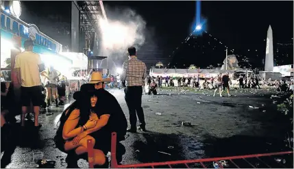  ?? Picture: DAVID BECKER/GETTY IMAGES ?? SHOOTING AFTERMATH: People take cover after a gunman opened fire at a music festival in Las Vegas