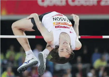  ?? DITA ALANGKARA, THE ASSOCIATED PRESS ?? Nanoose Bay’s Michael Mason flies over the bar during the men’s high jump final at Carrara Stadium in Gold Coast, Australia, on Wednesday. Mason would finish sixth overall.