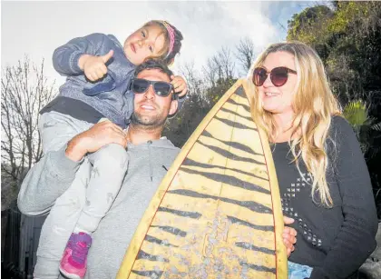  ?? Photo / Paul Taylor ?? Shon Turfrey with his daughter Ava Turfrey and partner Sarah Spence. Shon was swept out to sea while surfing at Haumoana on the Cape Coast.