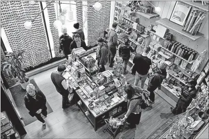  ?? [ANDREA NOALL/DISPATCH PHOTOS] ?? Shoppers browse a selection of items at Tigertree during Small Business Saturday in the Short North.