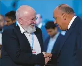  ?? PETER DEJONG/AP ?? The EU’S Frans Timmermans, left, and Sameh Shoukry, chief of the COP27 climate summit Sunday. Timmermans says a new deal doesn’t do enough to cut emissions.