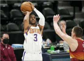  ?? DAVID ZALUBOWSKI — THE ASSOCIATED PRESS ?? Phoenix Suns guard Chris Paul, left, shoots for a basket as Denver Nuggets center Nikola Jokic defends in the first half of Game 4of an NBA second-round playoff series Sunday, June 13, 2021, in Denver.