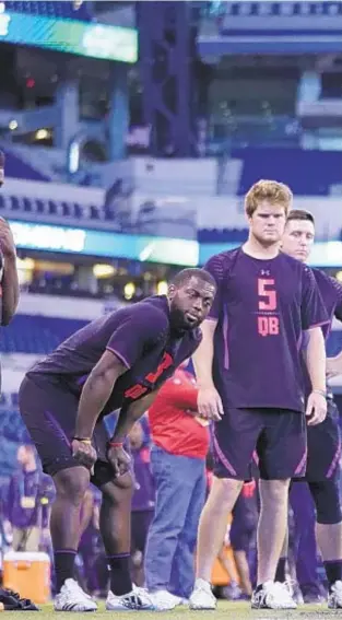  ??  ?? Then-Wyoming quarterbac­k Josh Allen competes in broad jump as future Jet Sam Darnold (5) looks on at last year’s quarterbac­k-stacked NFL Combine. GETTY