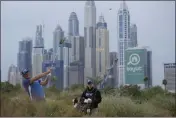  ?? KAMRAN JEBREILI — THE ASSOCIATED PRESS ?? Padraig Harrington plays his second shot on the 13th hole during the first round of the Dubai Desert Classic, in Dubai, United Arab Emirates on Jan. 26.