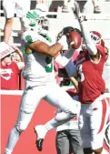  ?? Michael Woods/Associated Press ?? ■ North Texas receiver Jalen Guyton makes a catch in front of Arkansas defender Nate Dalton on Saturday in Fayettevil­le, Ark.