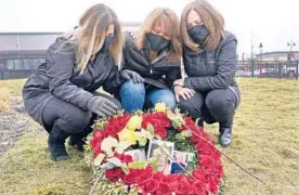  ?? ELISE AMENDOLA/AP ?? Michelle Pepe, left, Jill Federman and Lisa Post Mazerolle mourn March 1 in Lynnfield, Mass. The fathers of the three women all died from COVID-19 in April 2020.