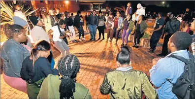  ?? Picture: EUGENE COETZEE ?? SHOW OF SOLIDARITY: A group of about 50 NMU students gathered outside the Second Avenue campus last night in a show of solidarity after the brutal attack on two students on Monday night. During the vigil, students sang struggle songs before being...