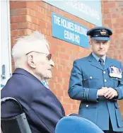  ?? ?? Hero Left , Ernie is presented with a medal and above, Ernie Holmes and OC ESUAS in front of ‘The Holmes Building’