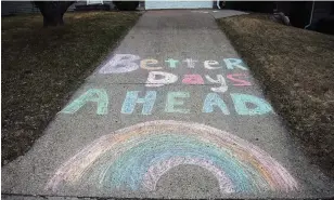  ?? JIM MONE THE ASSOCIATED PRESS FILE PHOTO ?? A chalk message and rainbow decorate a driveway outside a home in Bloomingto­n, Minn.