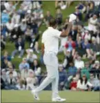  ?? RYAN KANG — THE ASSOCIATED PRESS ?? Tiger Woods tips his cap to the spectators on the 18th green after finishing the second round of the Genesis Open at Riviera Country Club on Friday in Los Angeles.