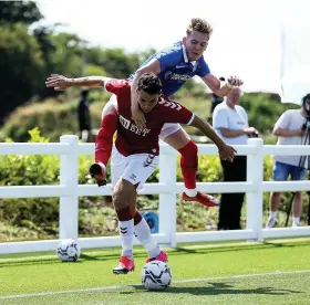  ??  ?? A Portsmouth player tries to stop City’s Matty James in an unorthodox way