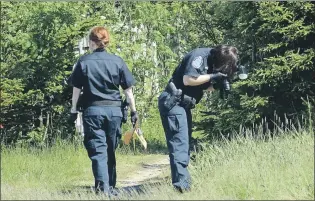  ?? KEITH GOSSE/THE TELEGRAM ?? Royal Newfoundla­nd Constabula­ry officers were on the scene near St. Peter’s church in Mount Pearl Monday, where items were found that might be linked to Cortney Lake’s disappeara­nce.