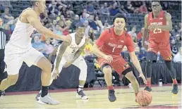  ?? PHELAN M. EBENHACK/AP ?? Maryland guard Anthony Cowan Jr. (1) drives to the basket in front of Harvard guard Justin Bassey (20) and guard Rio Haskett (5) during the Orlando Invitation­al on Friday.