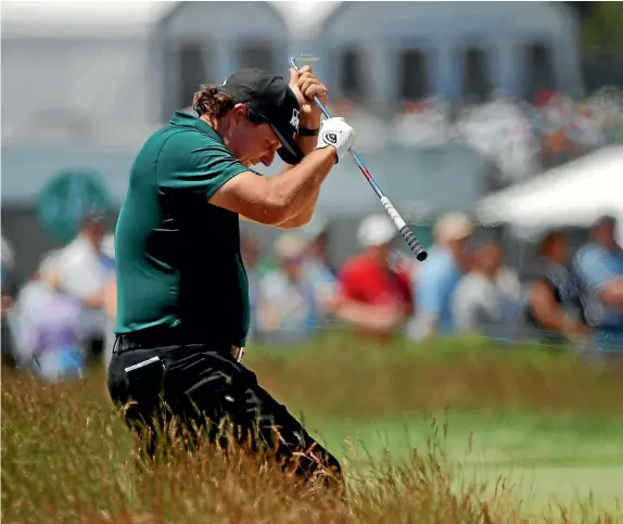  ?? AP ?? Phil Mickelson suffered a two-shot penalty for running after his golf ball on the 13th green at Shinnecock Hills and hitting it while it was still moving.