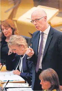  ?? Pictures: Andrew Cowan. ?? Conservati­ve education spokeswoma­n Liz Smith and Education Secretary John Swinney clashed during the Primary 1 Testing debate at Holyrood.