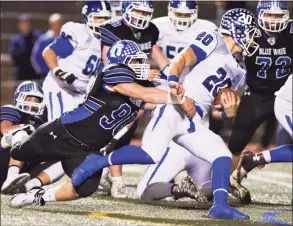  ?? Tyler Sizemore / Hearst Connecticu­t Media ?? Darien defensive end Mark Evanchick (90) drags down Southingto­n quarterbac­k Jasen Rose (20) in a 2015 CIAC tournament semifinal.