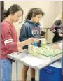  ?? SUBMITTED PHOTO ?? Lincoln FFA members Maria Otero and Tania Ortiz are making dill pickles with farm fresh cucumbers in Food Science 2.