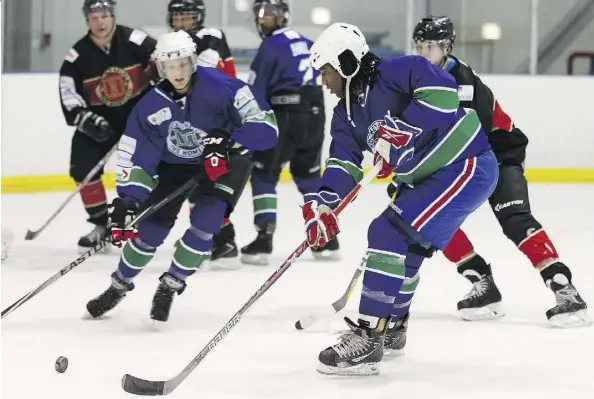  ?? IAN KUCERAK ?? Former Edmonton Oilers Georges Laraque plays for the AIM Building Maintenanc­e team against the Running Room & Formations team during the 4th annual Hockey Helps The Homeless Edmonton Tournament at Terwillega­r Community Recreation Centre on Friday.