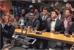  ?? PATTI PERRET ?? Malcolm X (Kingsley Ben-Adir, from left) takes a picture of his friends Jim Brown (Aldis Hodge), Cassius Clay (Eli Goree) and Sam Cooke (Leslie Odom Jr.) in “One Night in Miami.”