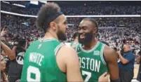  ?? (AFP) ?? Derrick White #9 and Jaylen Brown #7 of the Boston Celtics react after defeating the Miami Heat 104-103 in game six of the Eastern Conference Finals in Miami on Sunday.