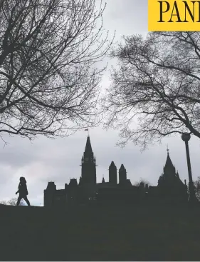  ?? JUSTIN TANG / THE CANADIAN PRESS ?? Parliament Hill is seen in relief as a person walks through Major’s Hill Park in Ottawa
on Saturday. On Sunday, Canada saw its lowest daily increase in COVID-19 deaths.