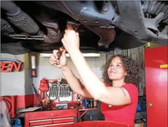  ?? PETE BANNAN — DIGITAL FIRST MEDIA ?? Patrice Banks, founder & CEO of Girls Auto Clinic, prepares an oil change. They are located at State Road and West Chester Pike in Upper Darby.