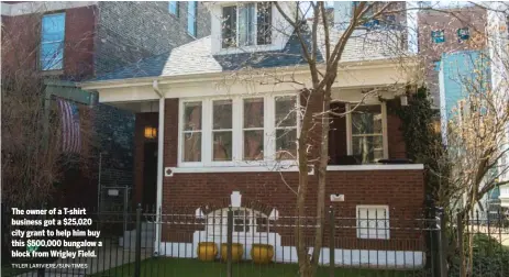  ?? TYLER LARIVIERE/ SUN- TIMES ?? The owner of a T- shirt business got a $ 25,020 city grant to help him buy this $ 500,000 bungalow a block fromWrigle­y Field.