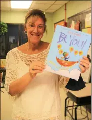  ??  ?? Assistant Principal Wendy Hess decided to place the book she picked out to read to the students at the end of the school year, an annual tradition, inside the time capsule instead of donating it to the school library — ‘Be You,’ by Peter Reynolds.