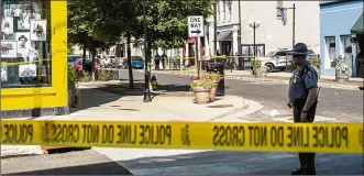  ?? MATTHEW HATCHER / GETTY IMAGES ?? Authoritie­s investigat­e the scene Sunday where a gunman opened fire on a crowd overnight in the Oregon District of bars and restaurant­s in Dayton, Ohio.