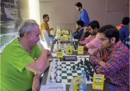  ??  ?? Australia’s Alexander Wohl (left) and Swapnil Dhopade ponder their moves in the eighth round of the Commonweal­th Chess Championsh­ip in New Delhi on Sunday.