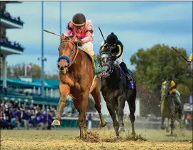  ?? ANDY LYONS / GETTY IMAGES ?? Game Winner, ridden by Joel Rosario, runs to victory Friday in the Breeders’ Cup Juvenile race at Churchill Downs in Louisville, Ky.