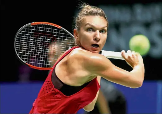  ?? — Reuters ?? Back to you: Romania’s Simona Halep returns a shot to France’s Caroline Garcia in the WTA Finals Red Group opener at the Singapore Indoor Stadium yesterday.