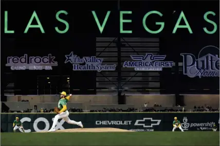  ?? PHOTOS BY ELLEN SCHMIDT — LAS VEGAS REVIEW-JOURNAL VIA AP ?? The A's Mitch Spence pitches to a Milwaukee batter during a spring training game Friday at Las Vegas Ballpark, home of the Triple-A Aviators.