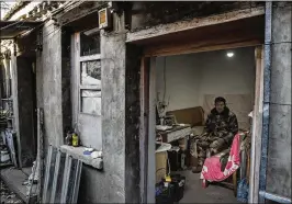  ??  ?? Bai Shichao, a delivery man who racked up more than $5,000 in debt from various Chinese online lending platforms, sits in his unheated room on the outskirts of Beijing. “It’s like gambling,” said Bai, whose work pays only $600 per month. “You start to gamble. Soon you get addicted to it.”