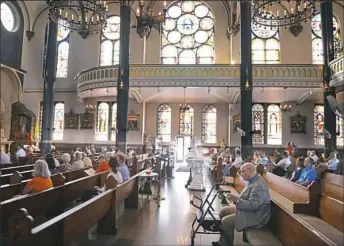  ?? Nate Guidry/Post-Gazette photos ?? Members of St. Stanislaus Kostka Church attend Mass on Sunday.