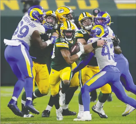  ?? DAN POWERS/USA TODAY SPORTS ?? Green Bay running back Aaron Jones breaks away for a large gain in the third quarter against the Los Angeles Rams last night. Jones ran for 99 of Green Bay's 188 rushing yards.
