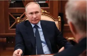  ?? Associated Press ?? ■ Russian President Vladimir Putin listens Friday to Krill Dmitriev, General Director of the Russian Direct Investment Fund, at the Kremlin in Moscow.