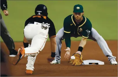  ?? NHAT V. MEYER — STAFF PHOTOGRAPH­ER ?? Chad Pinder, preparing to tag out the Giants’ Tyler Heineman in Tuesday’s exhibition game, has been a hitting standout during camp.