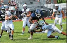  ?? SAM STEWART - DIGITAL FIRST MEDIA ?? Pottstown’s Isaiah Mayes runs through an arm tackle before being brought down by Sun Valley’s AJ Basht (58).