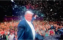  ?? — AFP ?? Newly- elected Mexico President Andres Manuel Lopez Obrador from the “Juntos haremos historia” party, cheers his supporters at the Zocalo Square after the results, in Mexico City, on Monday.